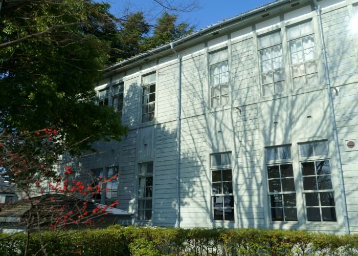 The Old Matsumoto High School building on the ground of Agatanomori Park is surrounded by trees